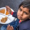 Indian school children eat their free midday meal at a government school in Haryana