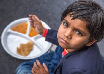 Indian school children eat their free midday meal at a government school in Haryana